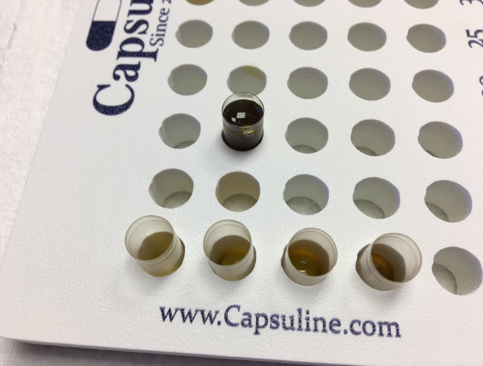 Varying levels of infused oil in capsules for microdosing.