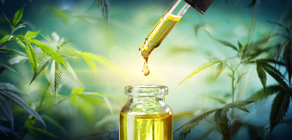 A jar & dropper of cannabis oil.