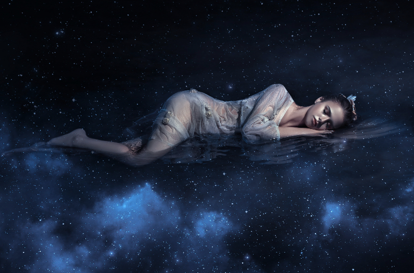 A woman floating asleep in space.